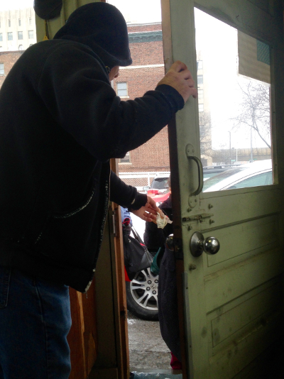 Gerry hands a parking lot patron a set of keys