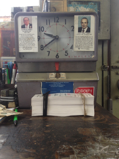 Gerry's time clock, which is adorned with the funeral placards of his former bosses