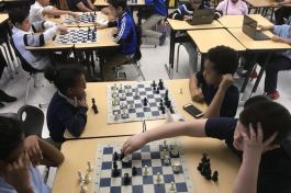 Mia Singleton, left, and Shaun Tinker, both in foreground, engage in a chess game during practice Tuesday at Munger Elementary-Middle School in Detroit