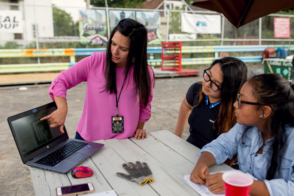 Lead mentor, Keysha Camps, going over SketchUp designs with Kandis and Brianna