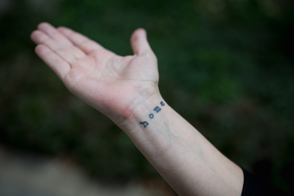 Tattoo on Mary Byrnes's wrist that reads "home"