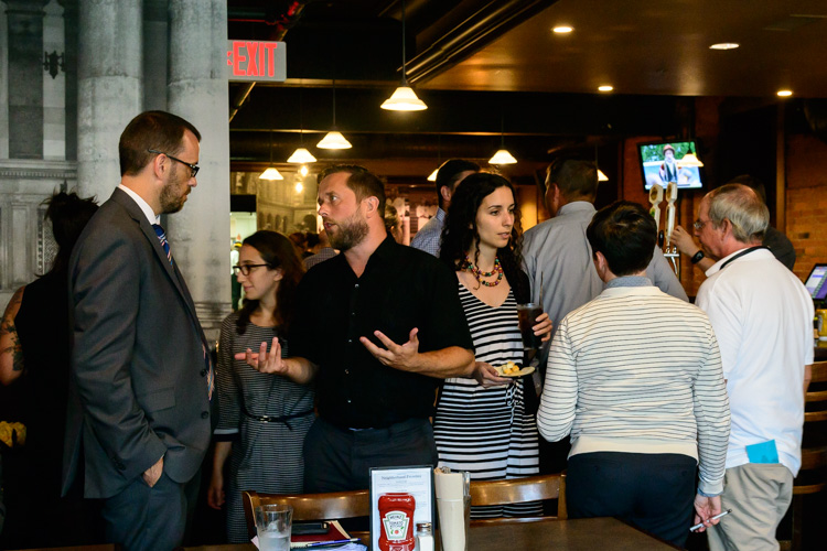 Attendees mingle before the panel