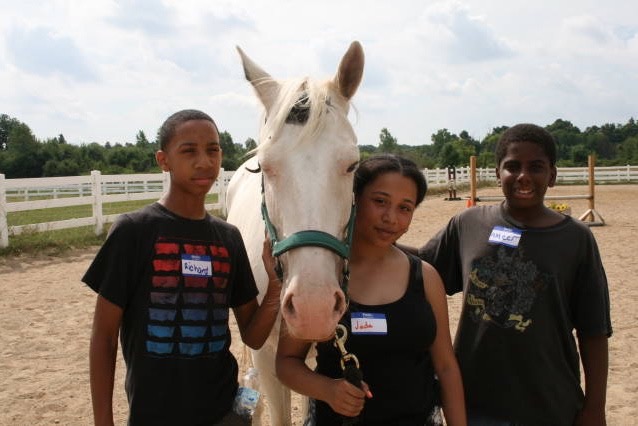 Richard, Jada, and Ameer interact with a Dewey (horse) through Detroit Horse Power