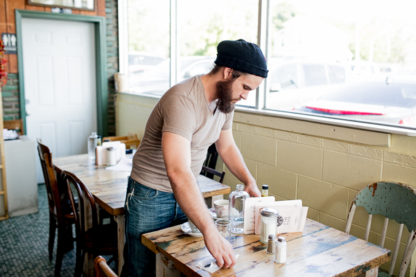 David Marshall clearing a table at Rose's Fine Foods