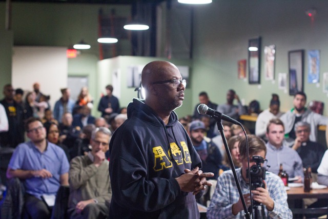 Audience member asks a question at a Live6 speakeasy event