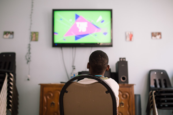 A young resident watches TV