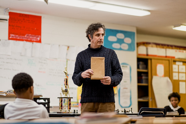 Teaching artist Peter Markus in a classroom at Marcus Garvey Academy