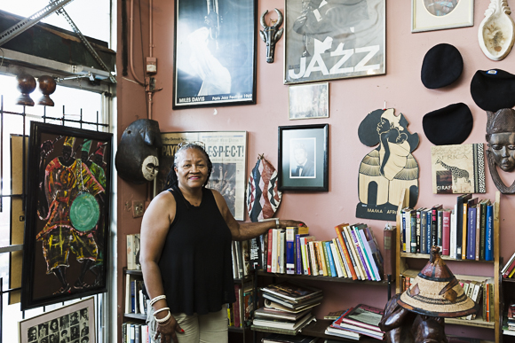Nandi amongst her cafe's collection of books and art