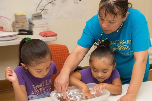 Classroom assistant Migdalia Price facilitates a science lesson at Brilliant Detroit