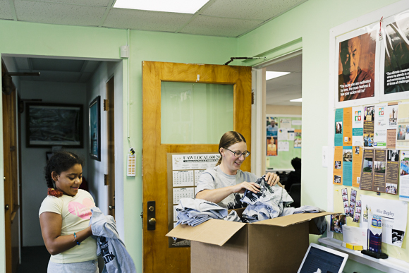 Alice Bagley and Kennedy Weakley sort TimeBank t-shirts