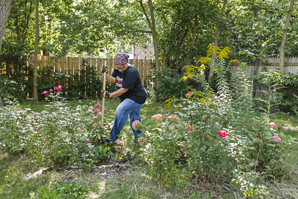 Beverly Frederick digs up weeds along Stahelin Avenue in NW Detroit