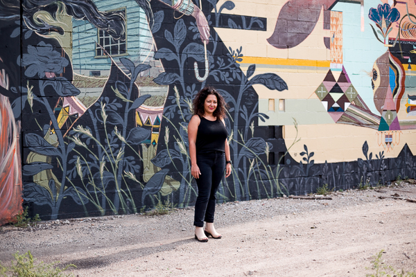 Roula David in front of a mural in Eastern Market