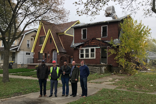 Members of the Tuxedo Project in front of the literary house while the abandoned house next door is demolished