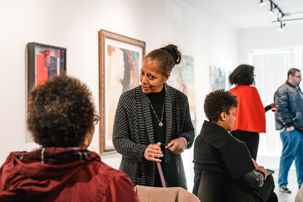 Attendees of a panel at NorWest Gallery mingle