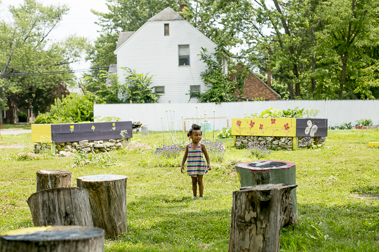 A little girl plays in the garden