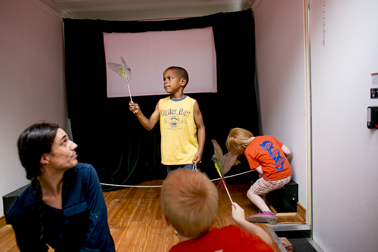 Children play with shadow puppets before a performance from CMAP