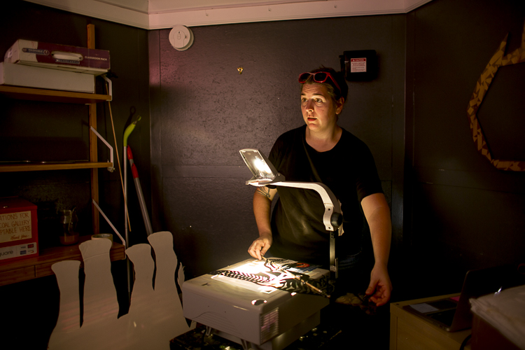 Carrie Morris works the projector during a performance