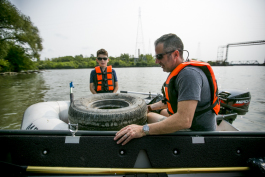 Tom and Mark pluck a tire from the water