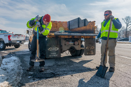 Matt Rikerwe and Devin Holtmeyer fix a pothole in Ferndale