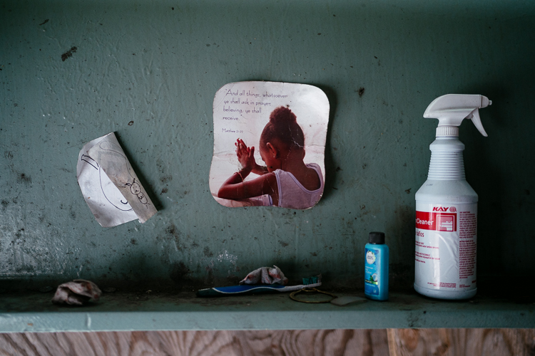 A tooth brush and picture tacked up on a girder near where Farr sleeps