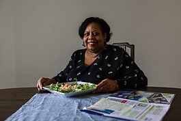 Fresh Conversations participant LaDonna Johnson prepares to eat a corn salad she made using a recipe she got from the program.