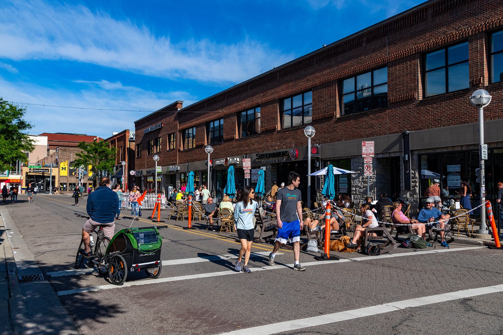 People walk and bike down Liberty Street in Ann Arbor.