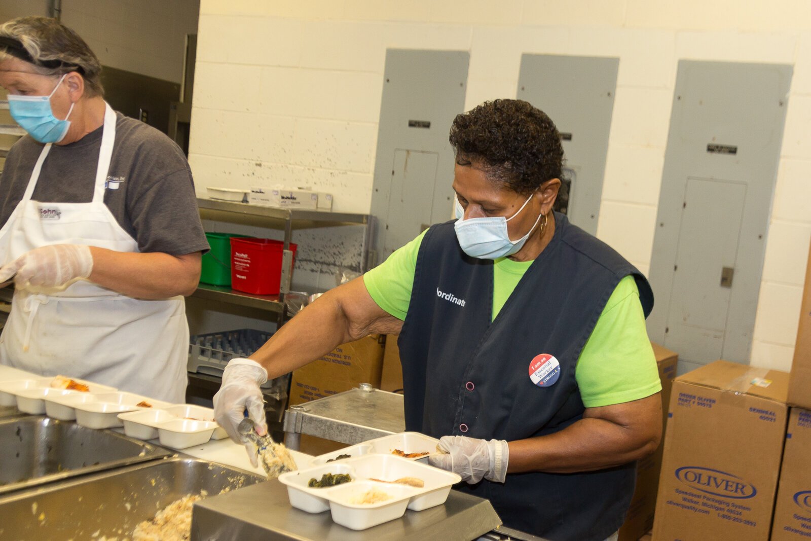 Doris Abbott, a volunteer for Senior Services Southwest Michigan, prepares meals for delivery.
