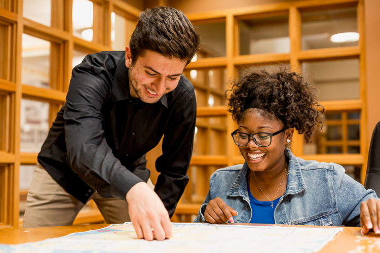 U-D Mercy students Momar Almadani and Yarnise Hines work on a project