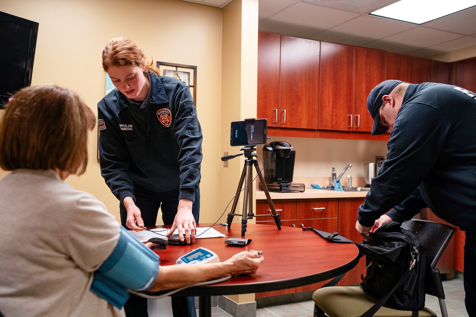 Community integrated paramedics Kim Whalen and Lt. Kevin Bailey of the Bloomfield Township Fire Department conduct a patient visit.