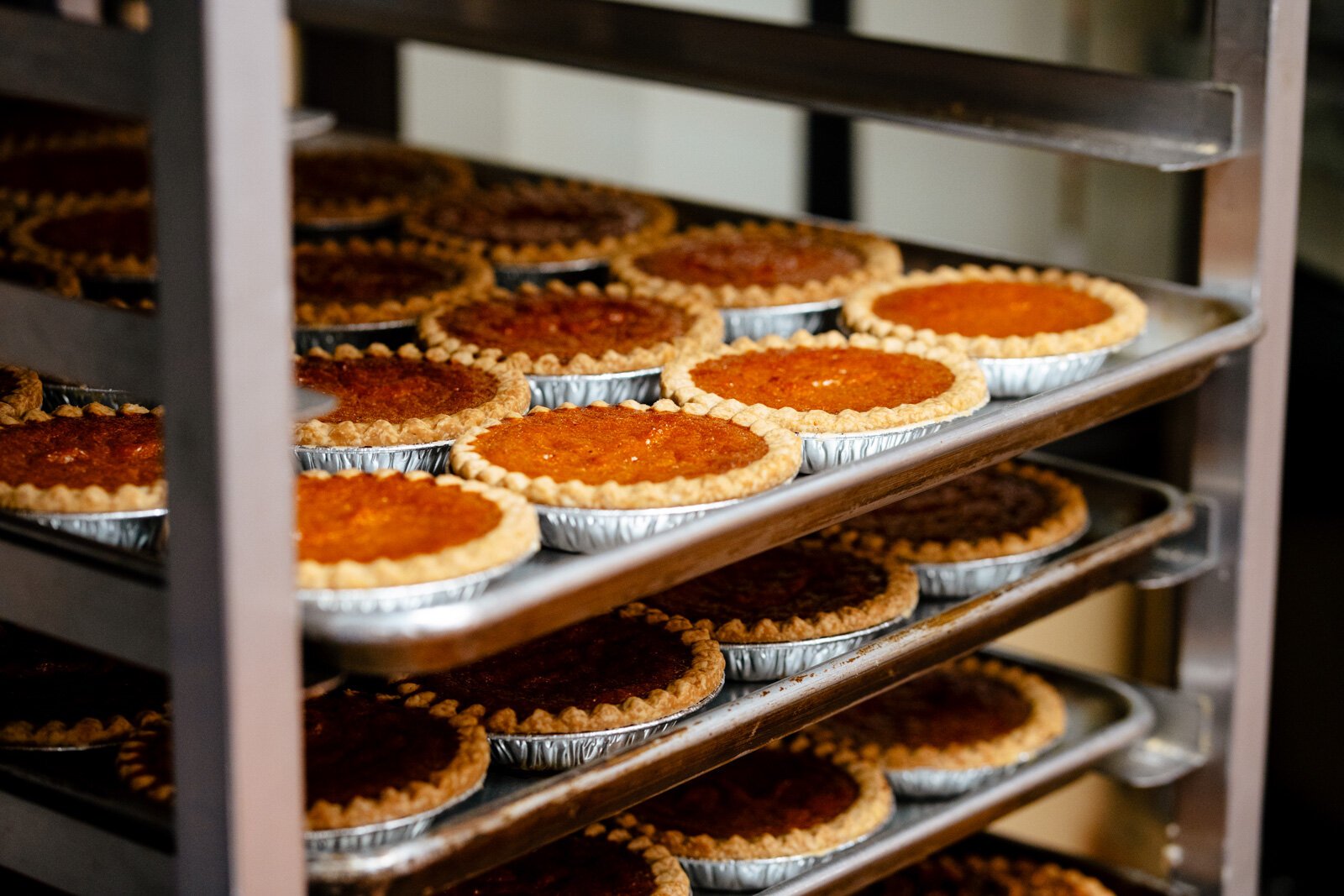 Racks of sweet potato pies in the kitchen.