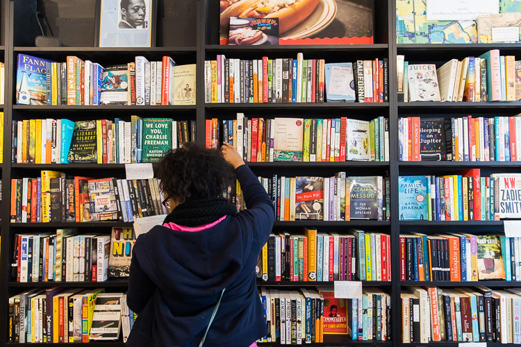 A River Rouge student browses the fiction section at Pages Bookshop