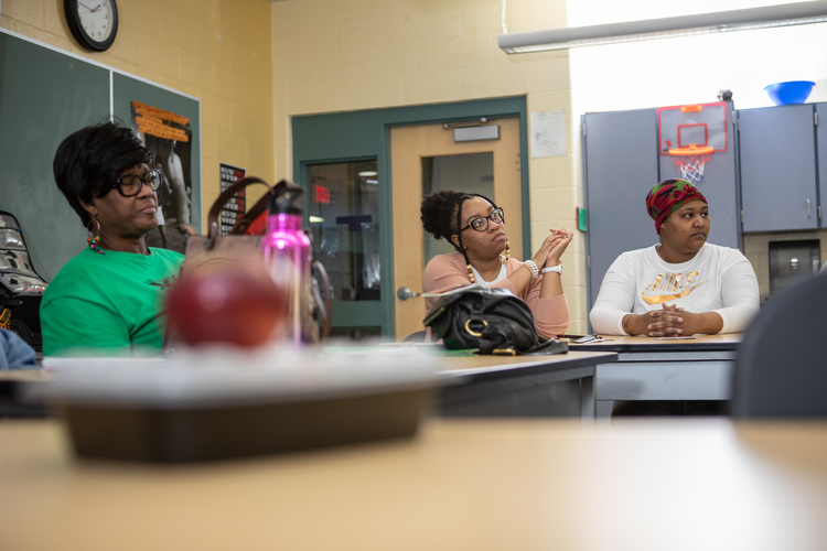 Cafeteria garden workers and volunteers discuss plans for their spring planting.