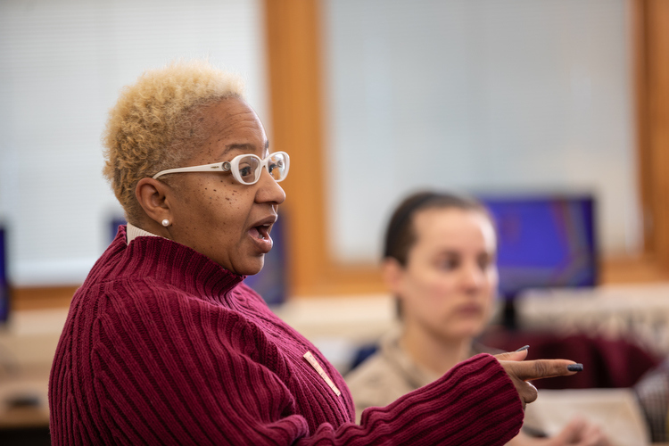 Lisa Oliver King of Our Kitchen Table talks with volunteers and cafeteria workers about menu choices.