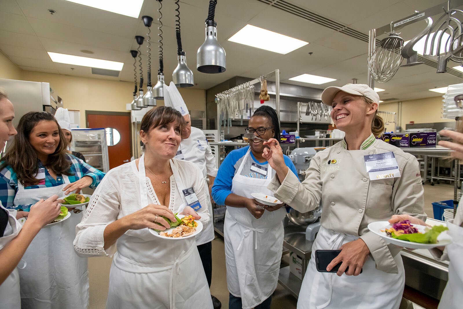 Mental health specialist, chef, and dietitian April Hackert (right in jacket) enjoys plant-forward recipes with participants at culinary medicine training offered by Groundwork Center.