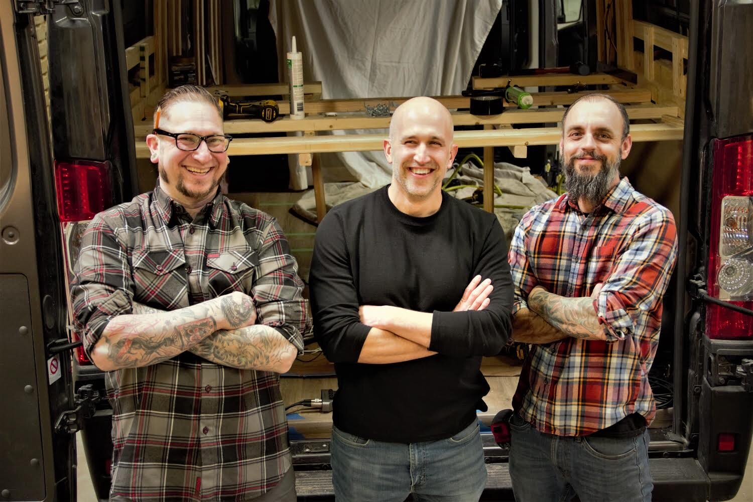 Drifter Vans co-owner/lead builder Kyle Silvey, left, co-owner/design consultant Paul Domish, center, and co-owner/lead carpenter Daren LeManski pose in front of a conversion project. Courtesy photo.