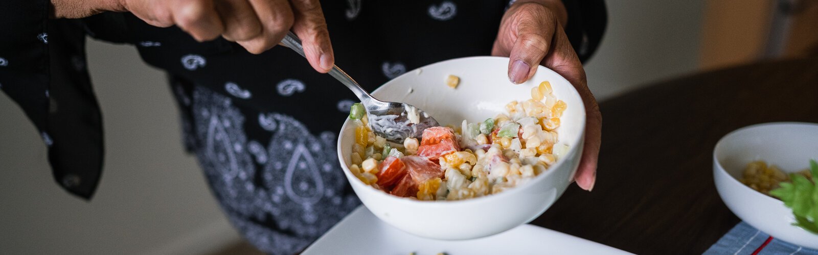 Fresh Conversations participant LaDonna Johnson makes corn salad using a recipe she got from the program.