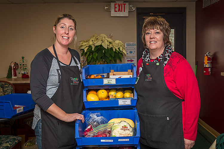 Sara Gould and Stacey Tilton with produce from the Veggie Mobile.