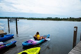 A kayaker heads out on the water with a rented Simple Adventures kayak.