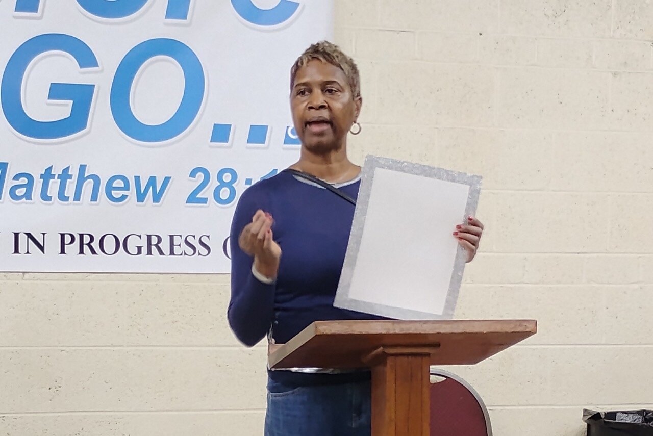 Thasha Murphy explains the vision board activity for guests of the Rotating Shelter
