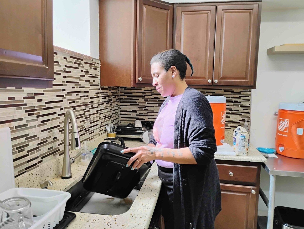 Vickey Carter-Ivory cleans up after an early-morning breakfast shift