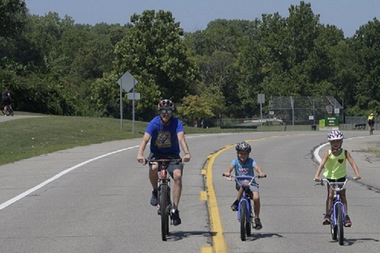 A family biking at Saturday in the Park.