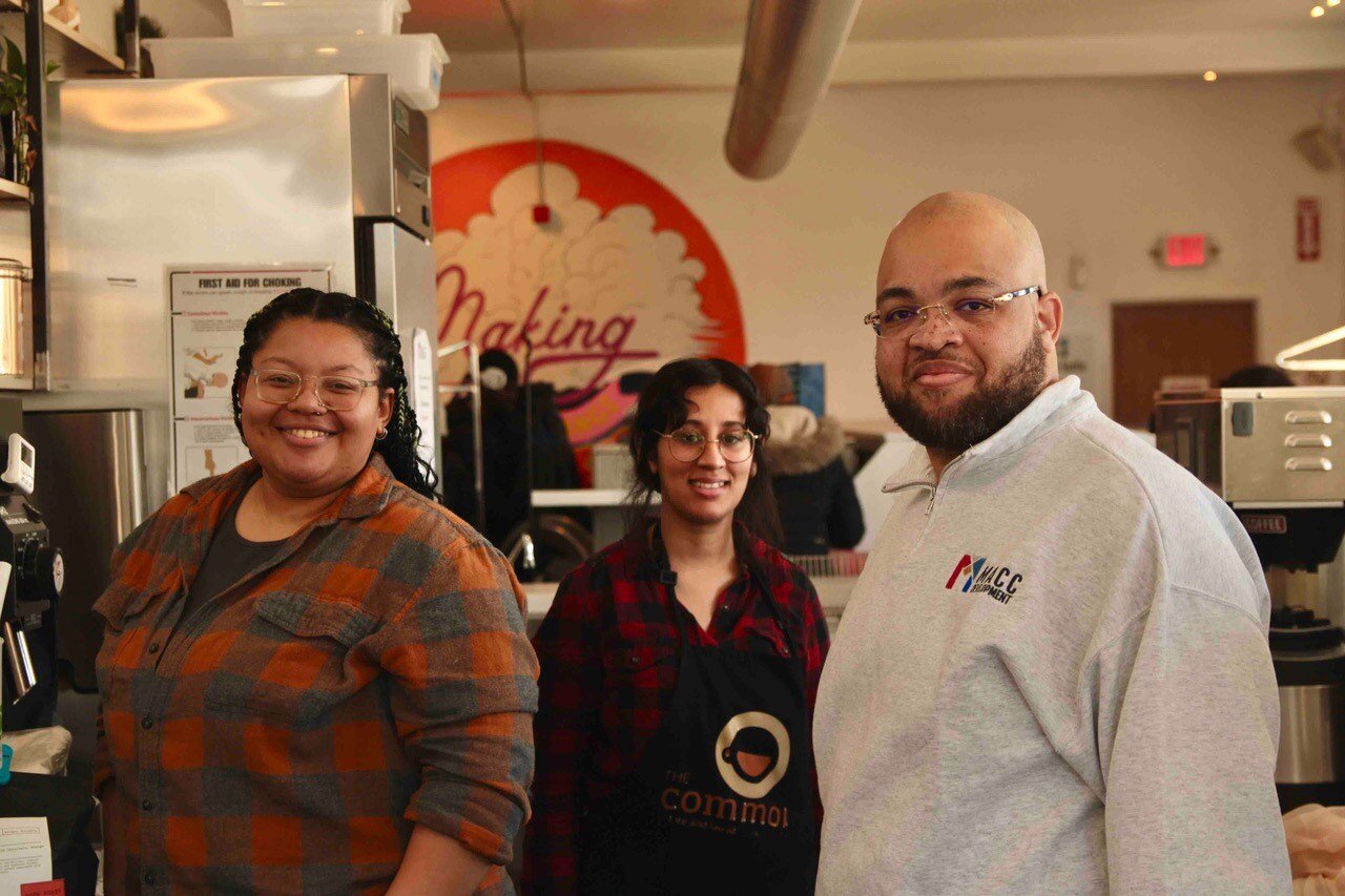 Antoine Jackson, Executive Director of MACC Development with employees of The Commons, a coffee shop and laundromat located in the same building as MACC Development.