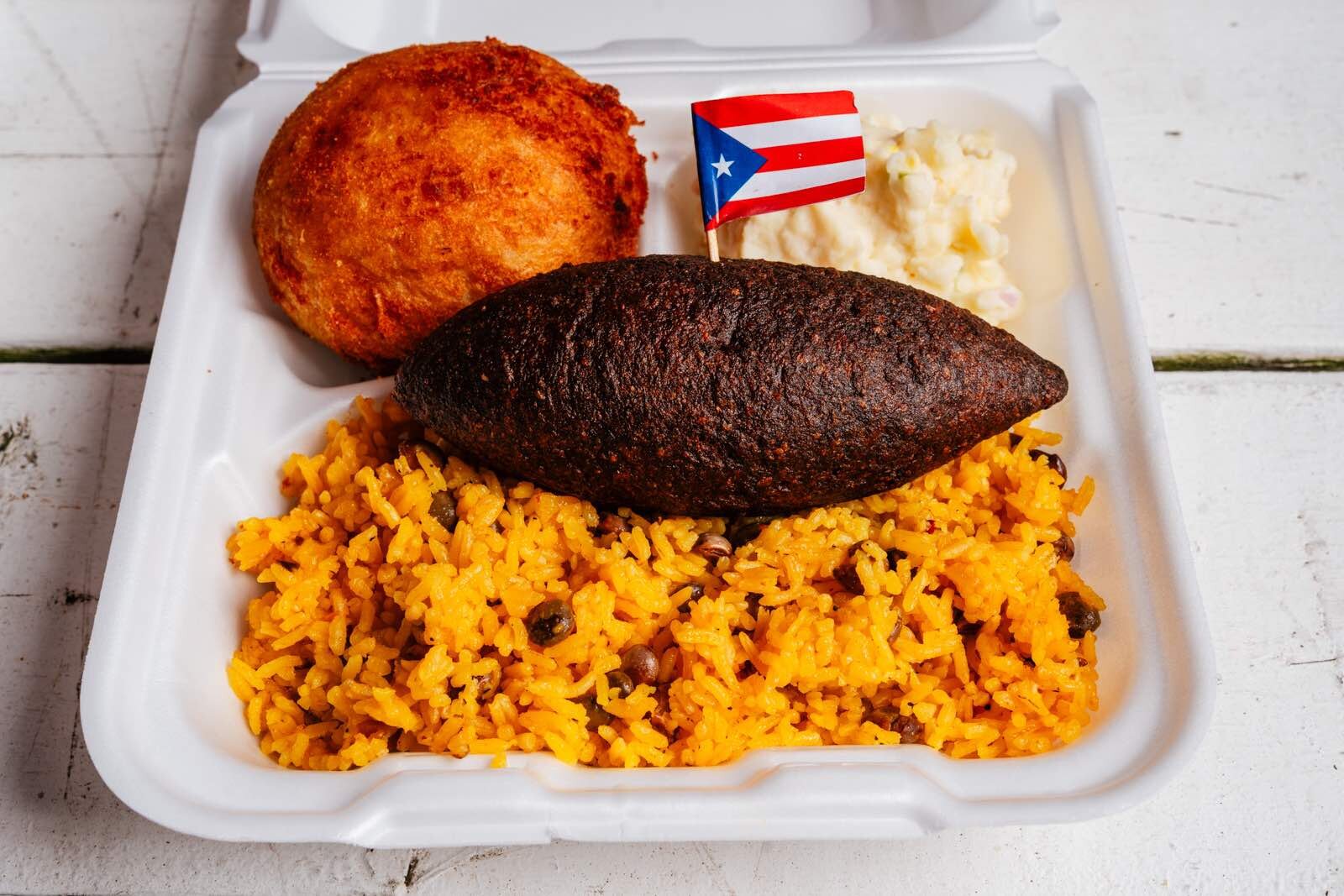 Rice and pigeon peas with an alcapura, a Puerto Rican fritter, at El Amanecer in Ecorse