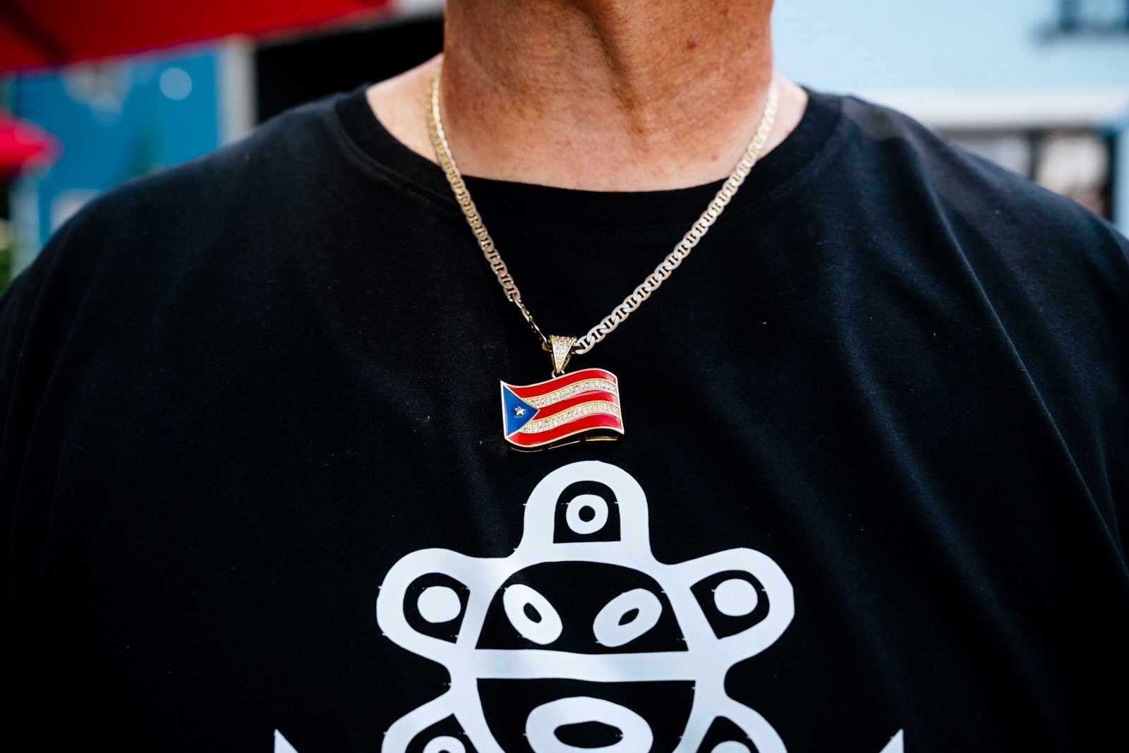 Alberto Ruiz, owner of El Amanecer in Ecorse, wears a medallion of the Puerto Rican flag 